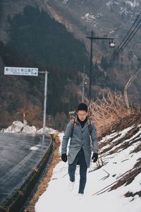 Full length of man standing in snow