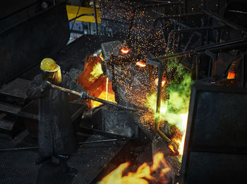 Industry, worker at furnace during melting copper, wearing a fire proximity suit