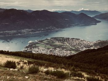 High angle view of lake and mountains against sky