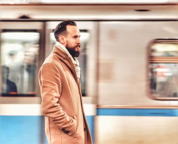 Full length of man standing at subway station