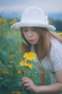 Close-up of a beautiful young woman with red flower