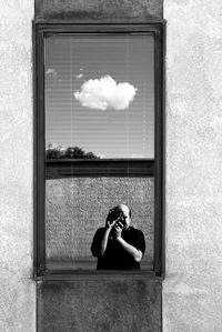 Reflection of man in glass window