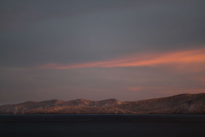 Scenic view of mountains against sky at sunset