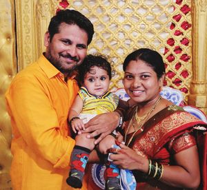 Portrait of happy parents holding daughter