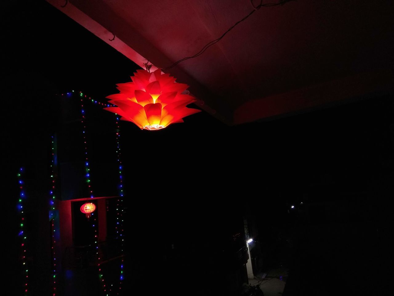 LOW ANGLE VIEW OF ILLUMINATED LIGHTING EQUIPMENT AGAINST SKY AT NIGHT