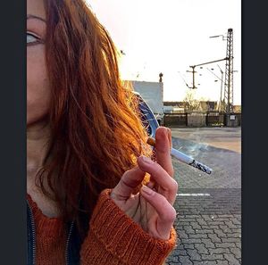 Rear view of young woman standing on street