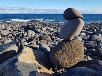 View of pebbles on beach against sky