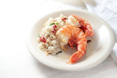 Close-up of food in plate against white background