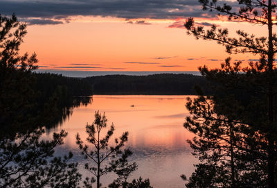 Scenic view of lake against romantic sky at sunset