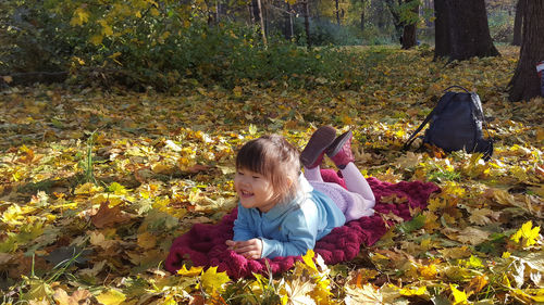 Full length of woman with autumn leaves