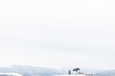 Scenic view of snowcapped mountains against clear sky