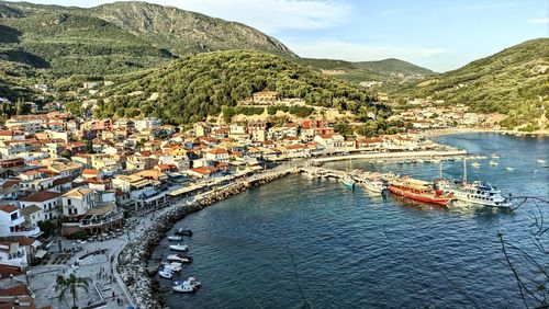 High angle view of townscape by sea against mountain