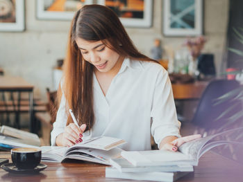 Close-up of young woman sitting on table