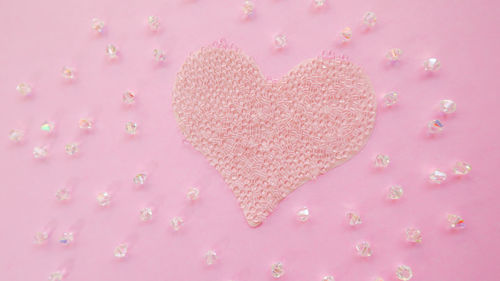 High angle view of heart shape on pink background