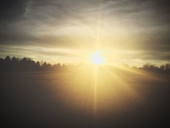 Scenic view of landscape against sky at sunset