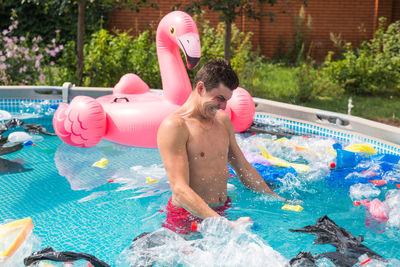 Full length of shirtless boy in swimming pool