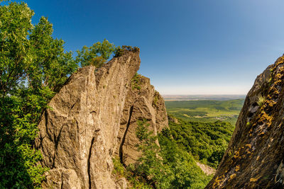 Panoramic view of trees and mountains against clear blue sky