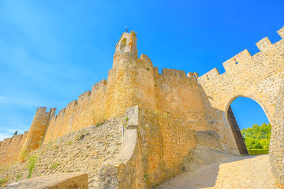 Low angle view of fort against blue sky