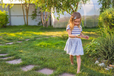 Full length of cute girl on field