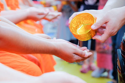 Midsection of people holding ice cream