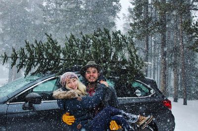 People in snow covered car