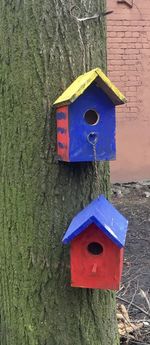 Close-up of mailbox on tree trunk against wall