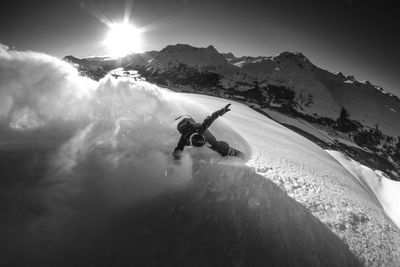 High angle view of a man snowboarding on the top of a mountain