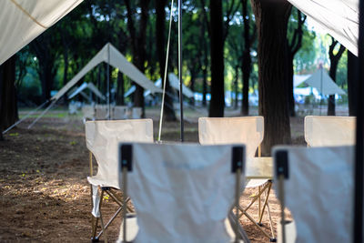 Empty chairs and tables in yard