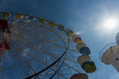 Low angle view of ferris wheel against sky