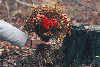 Cropped hand holding bouquet