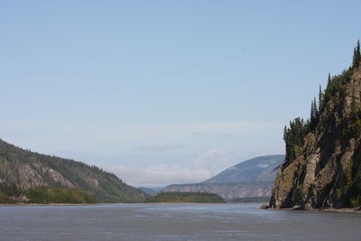 Scenic view of sea and mountains against sky