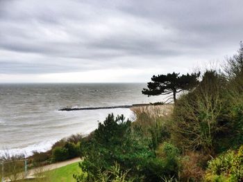 Scenic view of sea against cloudy sky