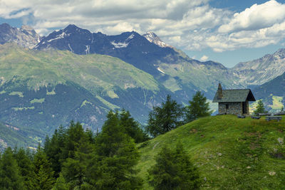 Scenic view of trees and mountains against sky