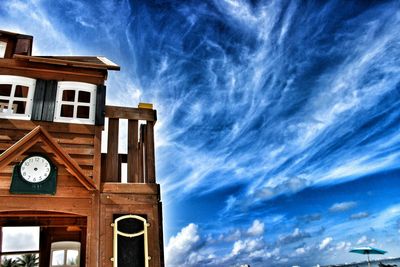 Low angle view of building against cloudy sky