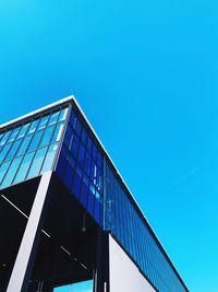 Low angle view of modern building against clear blue sky