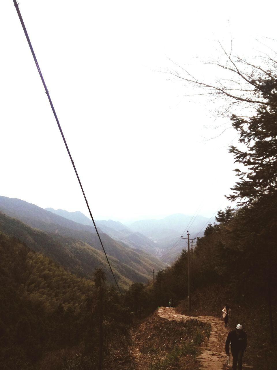 mountain, clear sky, landscape, tranquility, tranquil scene, mountain range, scenics, copy space, tree, nature, beauty in nature, the way forward, non-urban scene, leisure activity, men, countryside, remote, full length