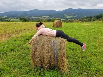 Rear view of woman on field against sky