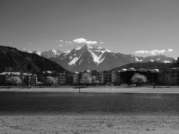 Scenic view of lake in front of snow capped mountains