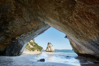 Scenic view of sea seen through cave