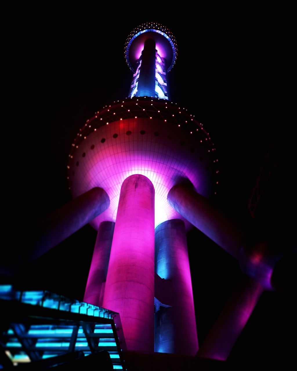 LOW ANGLE VIEW OF ILLUMINATED LIGHTING EQUIPMENT IN DARK