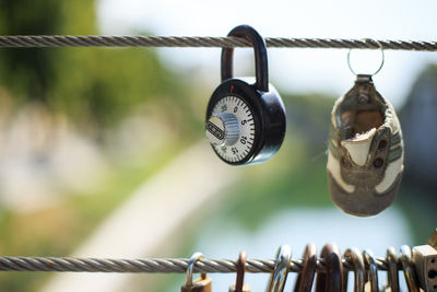 Close-up of padlocks hanging from metal cable