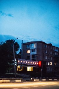 Train in city against sky at night