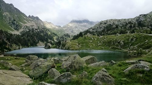Scenic view of lake and mountains against sky