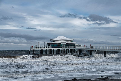 Lifeguard hut on beach against sky