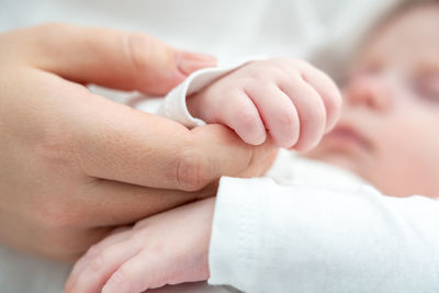 Close-up of couple holding hands