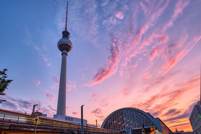 Local train with motion blur and the famous television tower in berlin at sunset