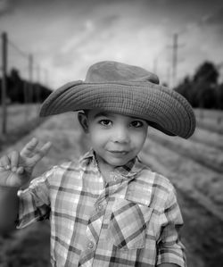 Portrait of woman wearing hat standing outdoors