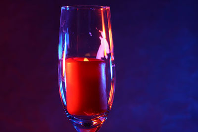 Close-up of beer glass against black background
