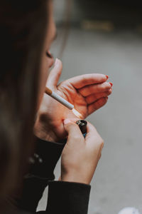 Close-up of woman hand holding cigarette