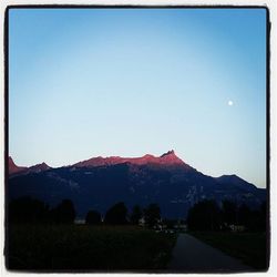 Country road leading towards mountains